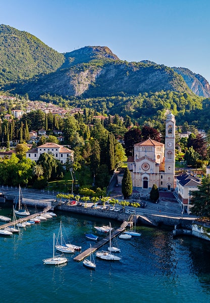 Church and marina on Lake Como with mountain backdrop