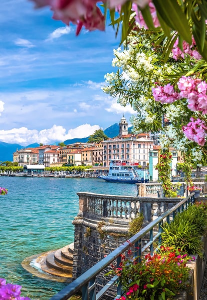 Scenic view of Bellagio on Lake Como with flowers and ferry